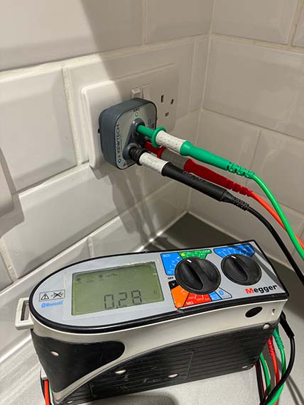 EICR Services - Electrician testing outlet on wall